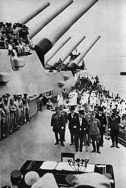 The Japanese signing the act of surrender on board the USS Missouri on Septemnber 2nd, 1945, marking the end of World War II.